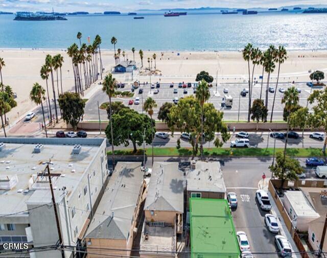 birds eye view of property featuring a water view and a view of the beach