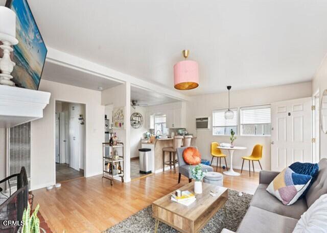 living room with ceiling fan and hardwood / wood-style flooring