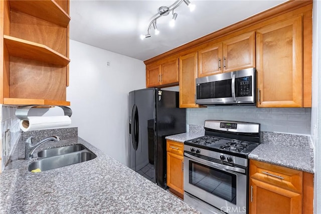 kitchen with sink, stainless steel appliances, and tasteful backsplash