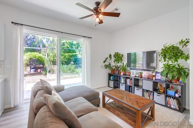 living room featuring ceiling fan and light wood-type flooring