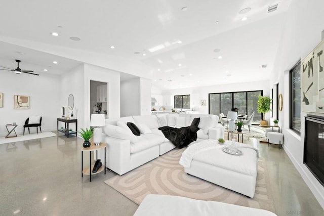 living room featuring ceiling fan and lofted ceiling