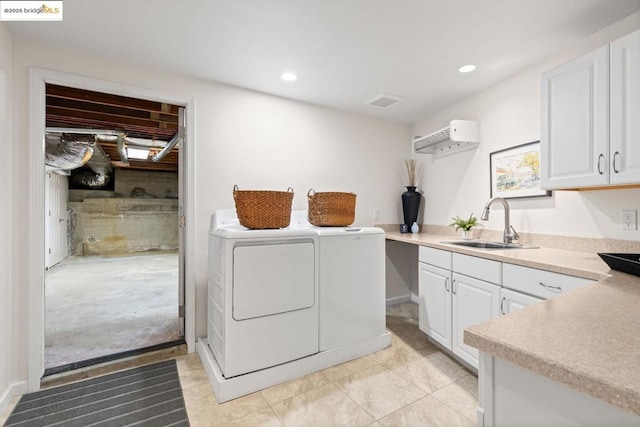 laundry room with cabinets, sink, washer and dryer, and light tile patterned flooring