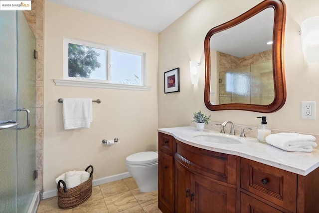 bathroom with an enclosed shower, vanity, and toilet