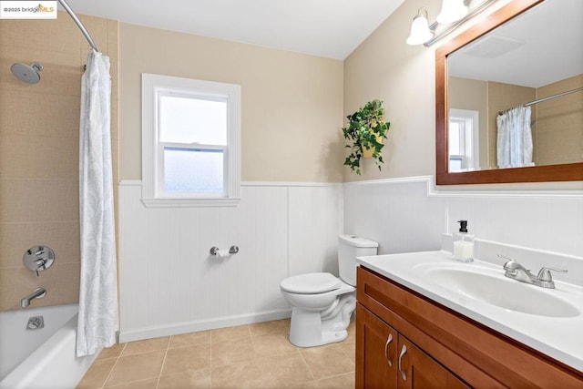 full bathroom featuring toilet, tile patterned flooring, vanity, and shower / bath combo with shower curtain