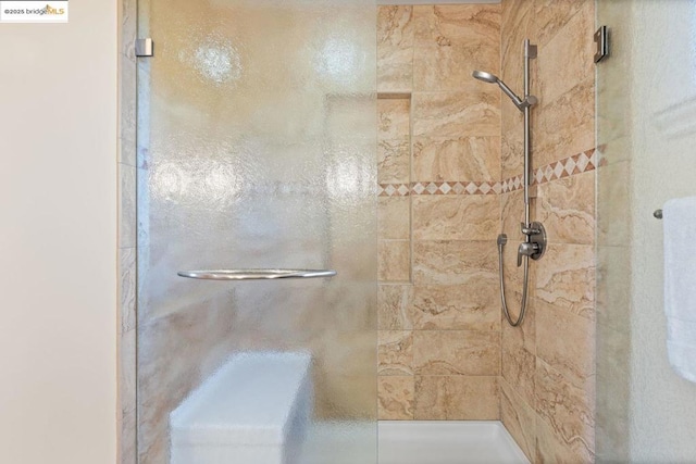 bathroom with a tile shower