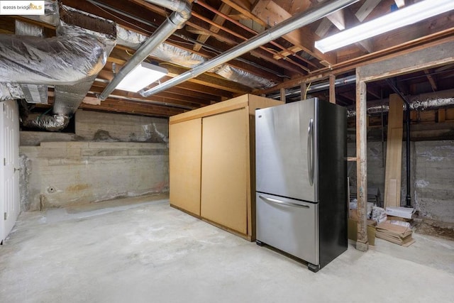 basement featuring stainless steel fridge