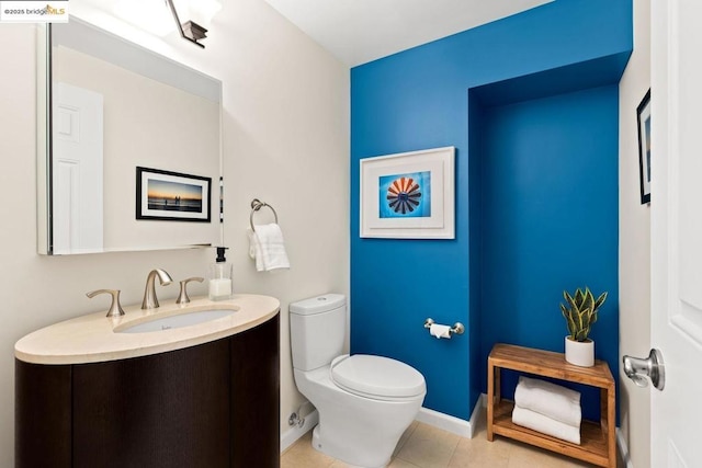 bathroom featuring toilet, tile patterned floors, and vanity