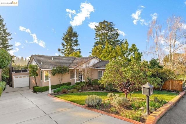 view of front of property with a front lawn and a garage