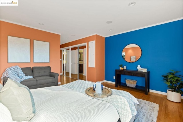 bedroom with hardwood / wood-style floors and ornamental molding