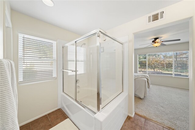 bathroom with tile patterned flooring, enclosed tub / shower combo, and ceiling fan