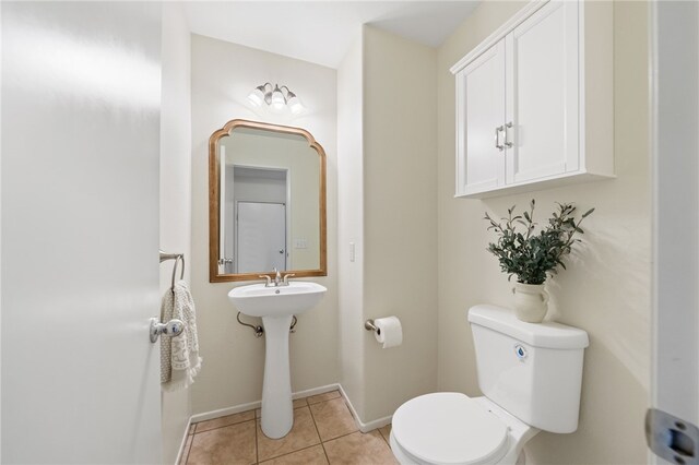 bathroom with tile patterned floors and toilet