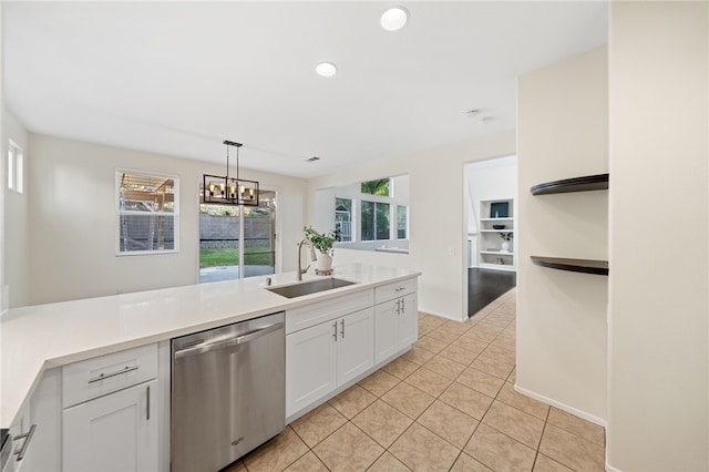 kitchen featuring sink, dishwasher, white cabinetry, hanging light fixtures, and a notable chandelier