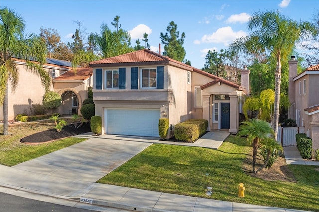 mediterranean / spanish-style home featuring a front yard and a garage