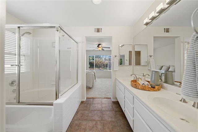 bathroom featuring ceiling fan, vanity, tile patterned flooring, and enclosed tub / shower combo