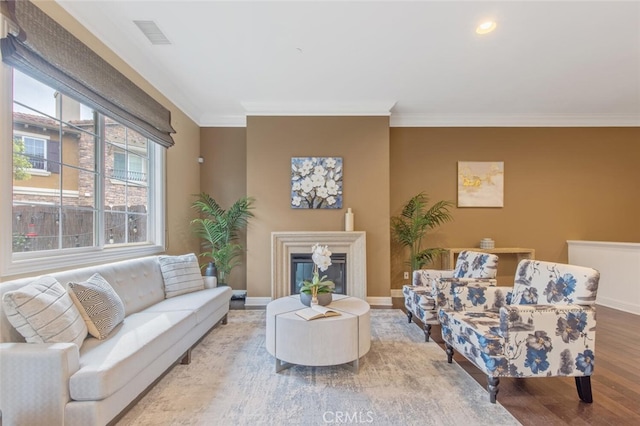 living room with crown molding and hardwood / wood-style flooring