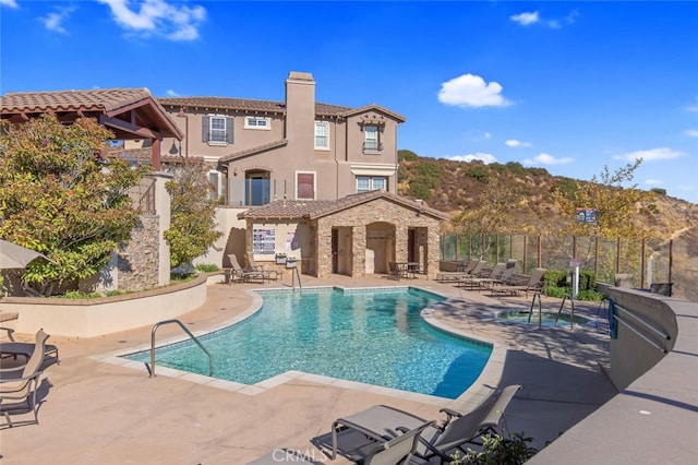 view of pool featuring a patio area and a mountain view