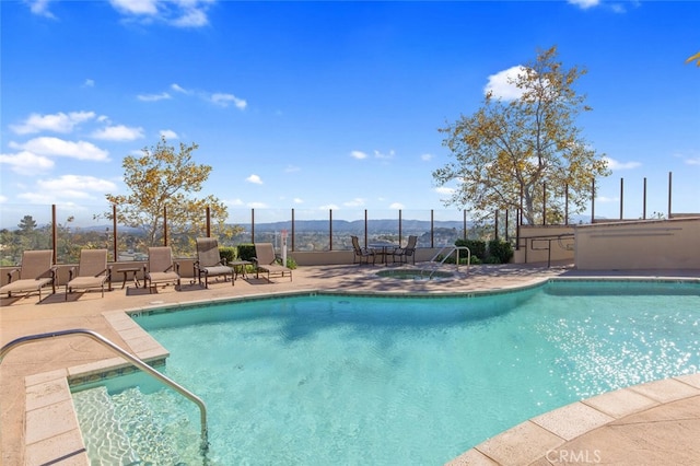 view of swimming pool with a patio area