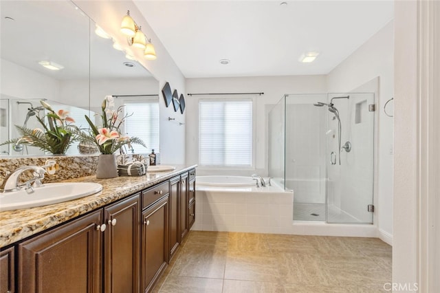 bathroom with vanity, tile patterned flooring, and plus walk in shower