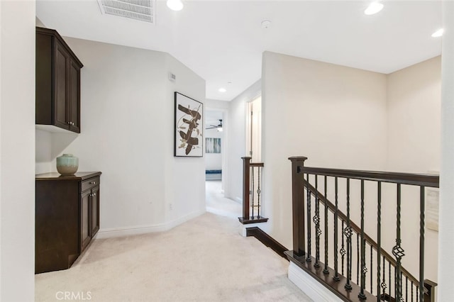 corridor with light colored carpet