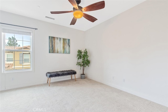 empty room featuring ceiling fan and carpet floors