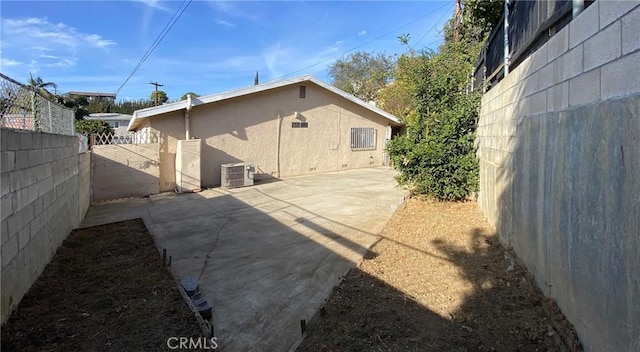 rear view of property featuring a patio area and central AC unit