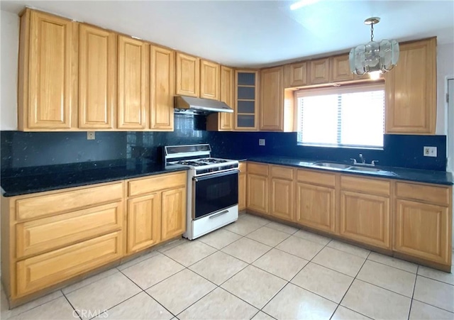 kitchen featuring pendant lighting, light tile patterned flooring, sink, an inviting chandelier, and white gas range