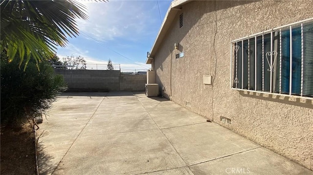 view of side of property with a patio