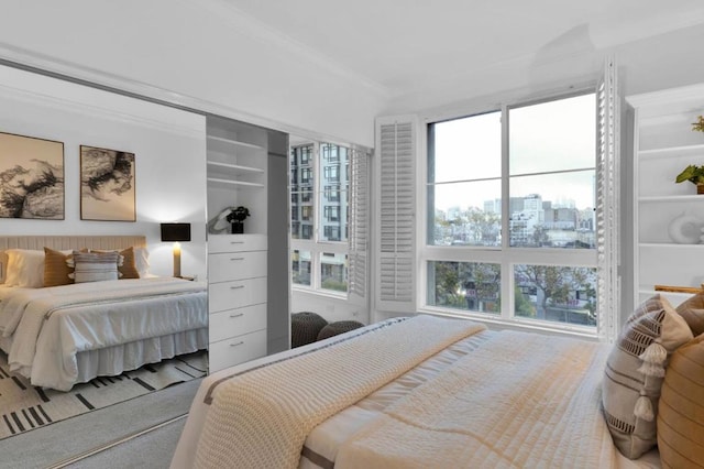 bedroom featuring light colored carpet and crown molding