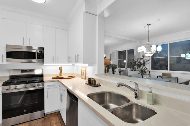 kitchen with decorative light fixtures, sink, stainless steel appliances, white cabinets, and a chandelier