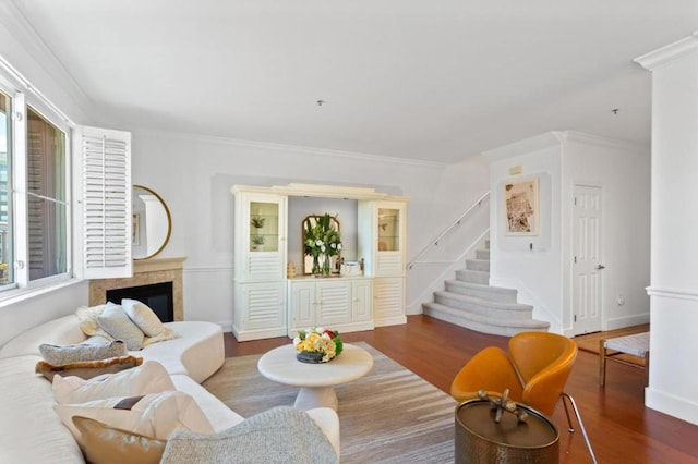 living room featuring a healthy amount of sunlight, dark hardwood / wood-style flooring, and crown molding