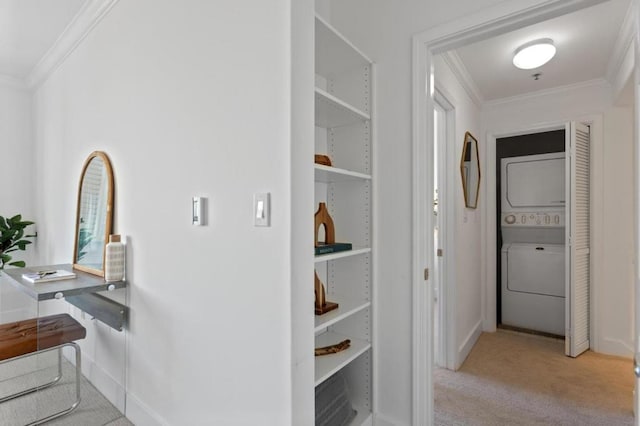 corridor featuring light colored carpet, crown molding, and stacked washer / dryer