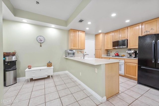 kitchen featuring appliances with stainless steel finishes, light brown cabinets, sink, kitchen peninsula, and light tile patterned flooring