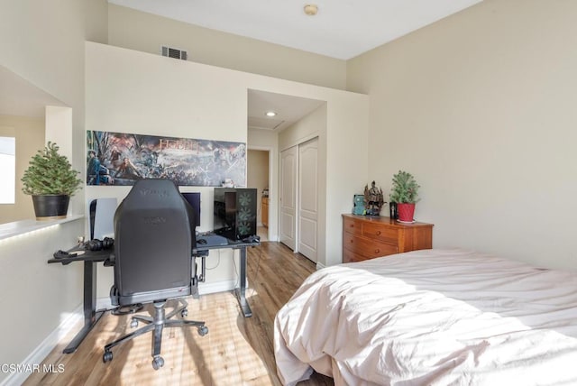 bedroom with a closet and light hardwood / wood-style flooring