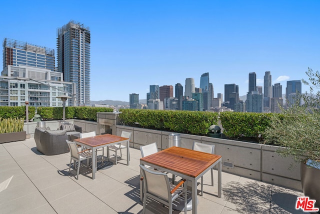 view of patio / terrace with an outdoor living space with a fireplace