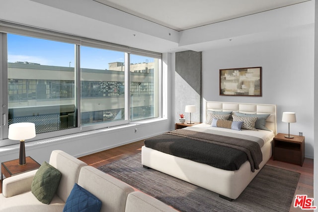 bedroom featuring dark wood-type flooring and multiple windows