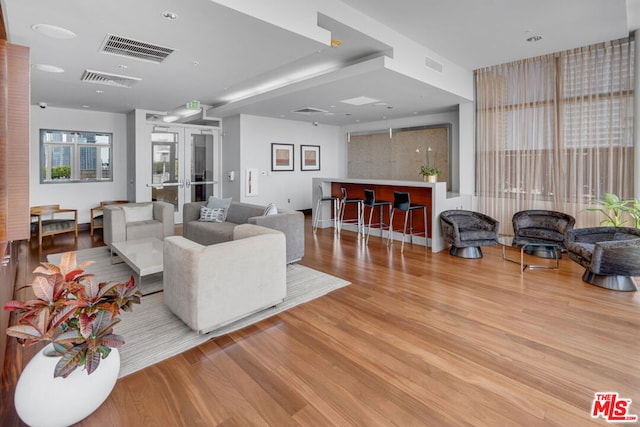 living room featuring light hardwood / wood-style floors and french doors