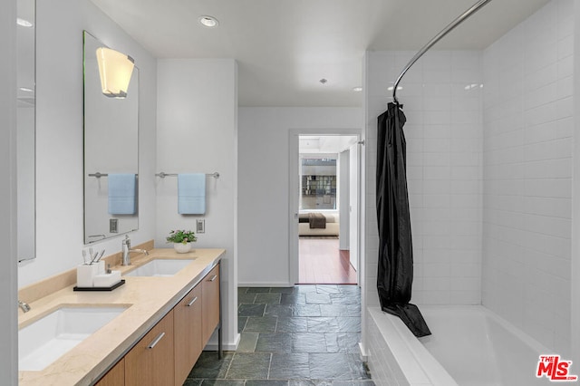 bathroom featuring vanity and shower / bath combo