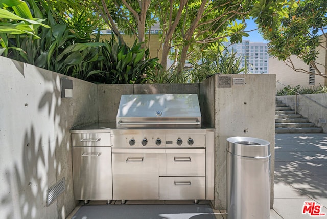 view of patio / terrace with exterior kitchen and a grill