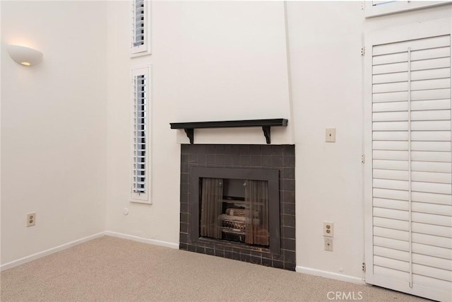 details with carpet and a tile fireplace