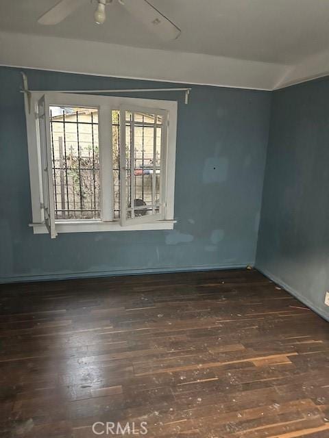 unfurnished room featuring ceiling fan, vaulted ceiling, and dark hardwood / wood-style floors