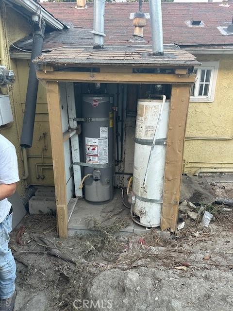 utility room featuring water heater