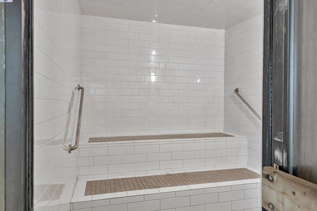 bathroom with tiled shower