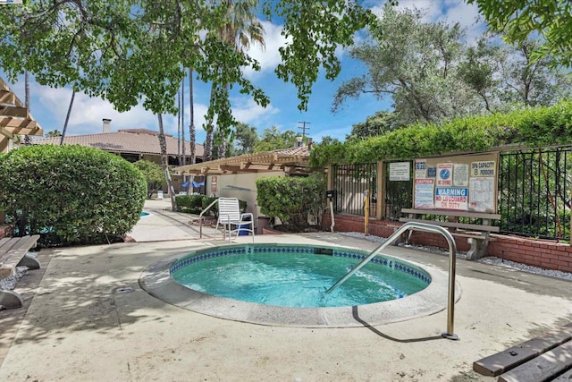 view of pool with a hot tub and a pergola