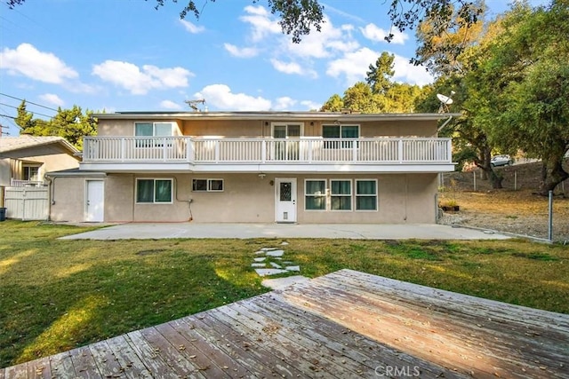 back of house with a deck, a yard, and a patio