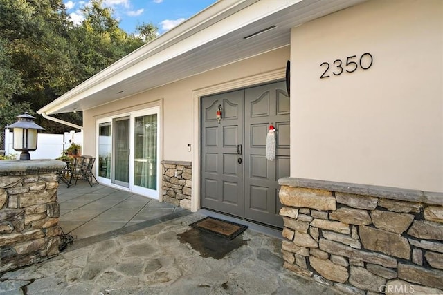 doorway to property featuring a patio area