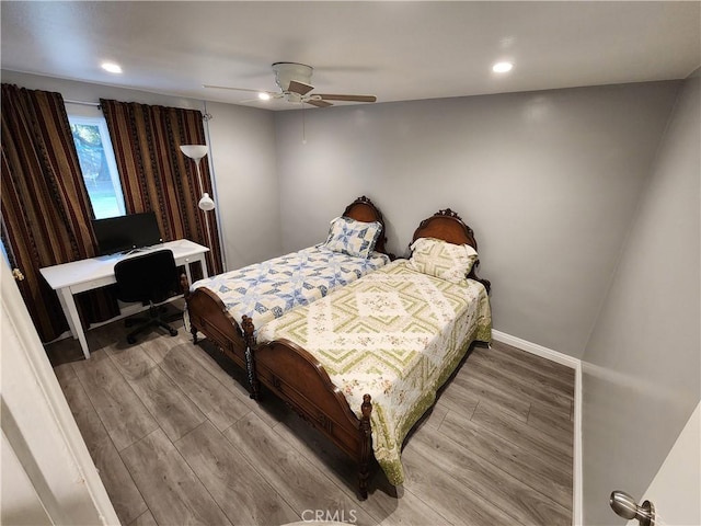 bedroom with ceiling fan and hardwood / wood-style flooring