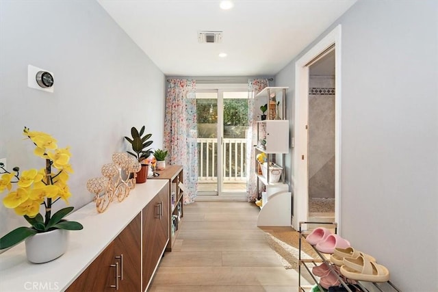 hallway with light hardwood / wood-style flooring