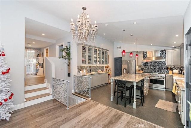 dining space featuring vaulted ceiling, dark wood-type flooring, and a chandelier