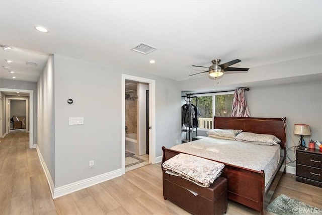 bedroom featuring ceiling fan, light hardwood / wood-style floors, and connected bathroom