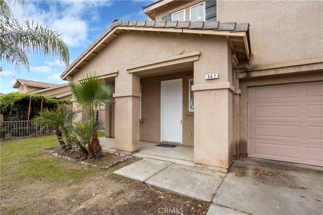 view of exterior entry with a garage